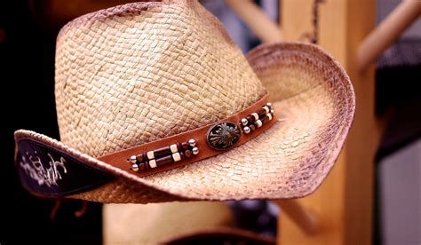 reshaping a straw cowboy hat.